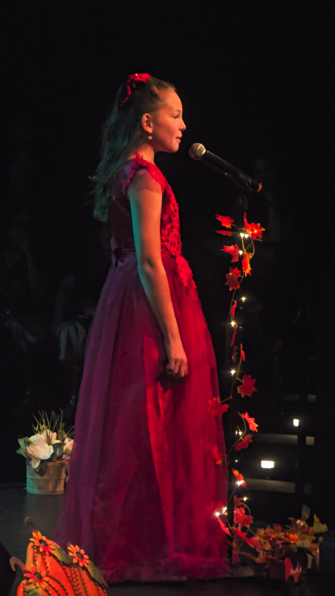 Vocalist performing in elegant red gown