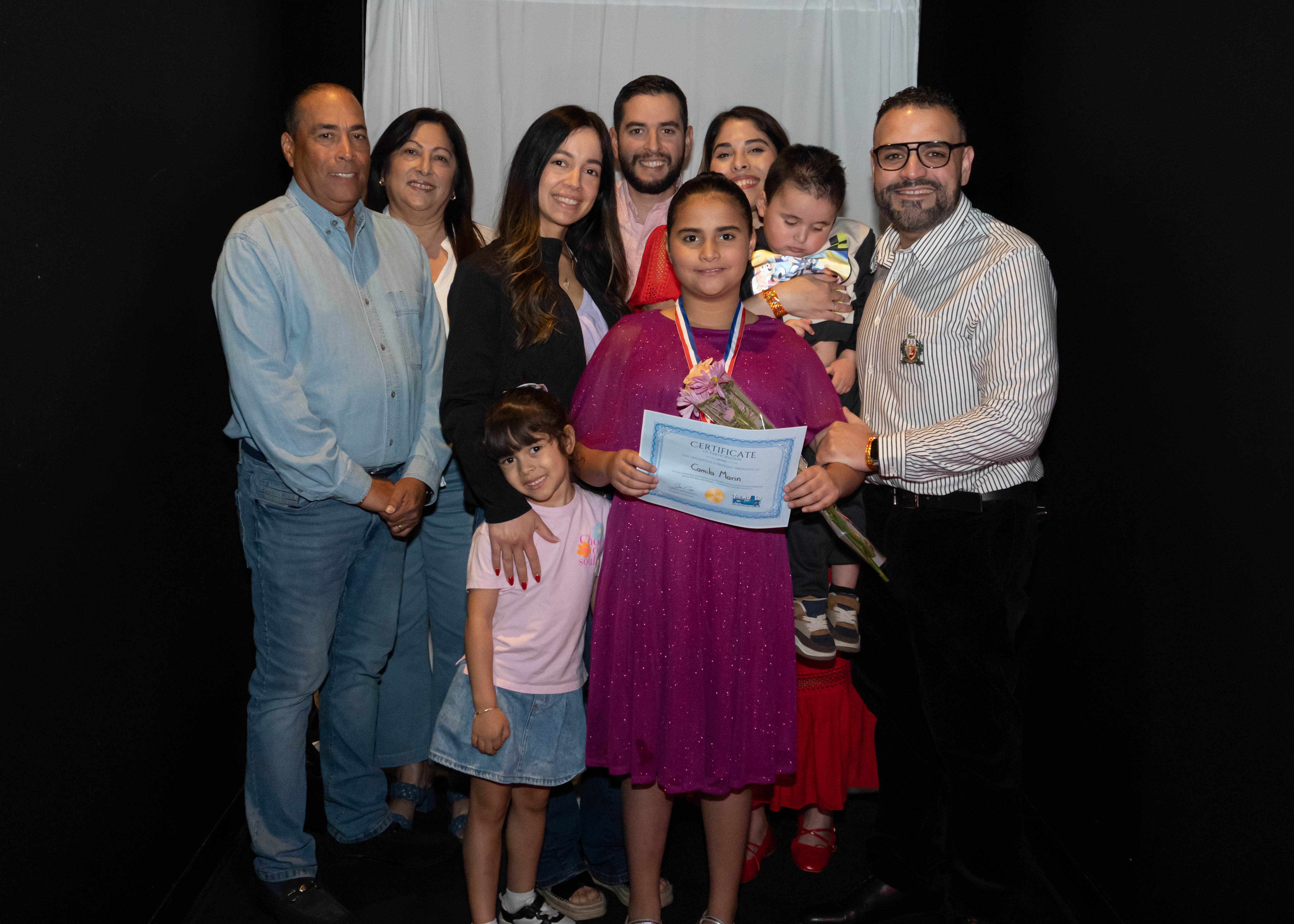 Family celebrating with young performer